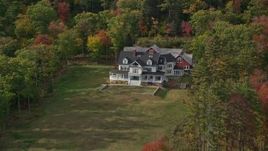 6K aerial stock footage approaching an isolated rural home, colorful foliage, autumn, Camden, Maine Aerial Stock Footage | AX148_113