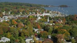 6k aerial stock footage orbiting a small coastal town, Camden Harbor, autumn, Camden, Maine Aerial Stock Footage | AX148_117