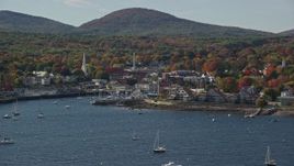 6k aerial stock footage flying by small coastal town, boats, autumn, Camden, Maine Aerial Stock Footage | AX148_122