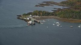 6K aerial stock footage flying by Grindel Point Light, islands, ferry, tilt down, autumn, Islesboro, Maine Aerial Stock Footage | AX148_124E