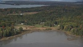 6K aerial stock footage flying by rural autumn, Isleboro Island, autumn, Islesboro, Maine Aerial Stock Footage | AX148_127