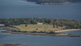 6K aerial stock footage approaching an isolated homes, autumn, Hog Island, Maine Aerial Stock Footage | AX148_132
