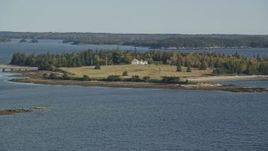 6K aerial stock footage approaching an isolated island home in autumn, Hog Island, Maine Aerial Stock Footage | AX148_133