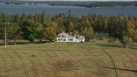 6K aerial stock footage approaching an isolated home, tennis court, tilt down, autumn, Hog Island, Maine Aerial Stock Footage | AX148_134E