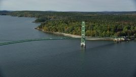 6k aerial stock footage flying by the Deer Isle Bridge in autumn, Little Deer Isle, Maine Aerial Stock Footage | AX148_140