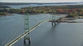 6K aerial stock footage orbiting the Deer Isle Bridge near a shore with trees, autumn, Deer Isle Bridge, Maine Aerial Stock Footage | AX148_141E