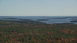 6K aerial stock footage flying by colorful forest, small islands in the bay, autumn, Brooklin, Maine Aerial Stock Footage | AX148_150