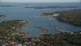 6K aerial stock footage flying over trees in autumn, approaching the Southwest Harbor, Maine Aerial Stock Footage | AX148_159E