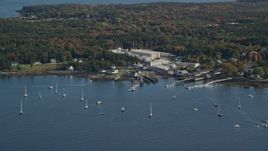 5.5K aerial stock footage flying by waterfront warehouse buildings, autumn, Southwest Harbor, Maine Aerial Stock Footage | AX148_162