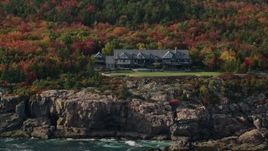 5.5K aerial stock footage flying by an isolated waterfront mansion, autumn, Seal Harbor, Mount Desert Island,  Maine Aerial Stock Footage | AX148_172