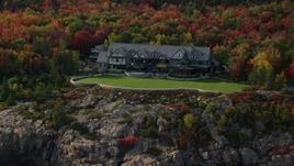 5.5K aerial stock footage approaching an isolated waterfront mansion, autumn, Seal Harbor, Maine Aerial Stock Footage | AX148_173E