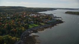 5.5K aerial stock footage flying over fall foliage in a small coastal town toward harbor, autumn, Bar Harbor, Maine Aerial Stock Footage | AX148_217E