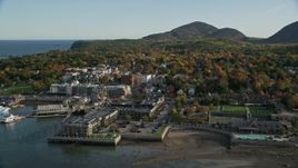 5.5K aerial stock footage flying over harbor along coastal town, hotels, houses and fall foliage, Bar Harbor, Maine Aerial Stock Footage | AX148_221E