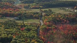 5.5K aerial stock footage following a road through the countryside with fall foliage, Bar Harbor, Maine Aerial Stock Footage | AX148_228
