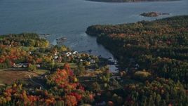 5.5K aerial stock footage flying by coastal neighborhood among fall foliage, Blue Hill, Maine Aerial Stock Footage | AX149_013E