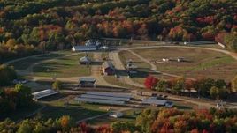5.5K aerial stock footage orbiting a race track and fairgrounds among fall foliage, Blue Hill, Maine Aerial Stock Footage | AX149_016