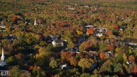 5.5K aerial stock footage flying along a small town with church steeples, nestled among fall foliage, Blue Hill, Maine Aerial Stock Footage | AX149_021