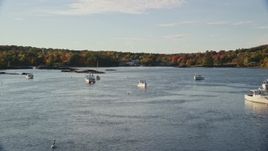 5.5K aerial stock footage flying over water with boats toward fall foliage, Blue Hill, Maine Aerial Stock Footage | AX149_024E
