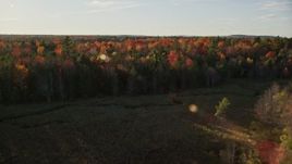 5.5K aerial stock footage flying over a forest with colorful trees and a clearing, autumn, Blue Hill, Maine Aerial Stock Footage | AX149_046E