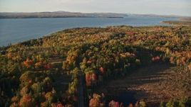 5.5K aerial stock footage approaching, flying over rural road through colorful forest, autumn, Castine, Maine Aerial Stock Footage | AX149_083E