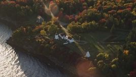 5.5K aerial stock footage flying by Fort Point Light, among fall foliage, autumn, Stockton Springs, Maine Aerial Stock Footage | AX149_088E