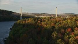 5.5K aerial stock footage tilt from river revealing the Penobscot Narrows Bridge, autumn, Stockton Springs, Maine Aerial Stock Footage | AX149_095E