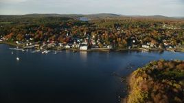 5.5K aerial stock footage flying by small coastal town, colorful trees in autumn, Bucksport, Maine Aerial Stock Footage | AX149_103