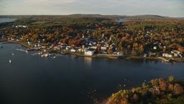 5.5K aerial stock footage flying by small coastal town, colorful trees in autumn, Bucksport, Maine Aerial Stock Footage | AX149_103E