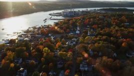 5.5K aerial stock footage orbiting a small coastal town nestled among fall foliage, autumn, Bucksport, Maine Aerial Stock Footage | AX149_105