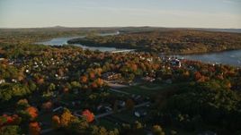 5.5K aerial stock footage flying over trees by a small town on Penobscot River, autumn, Bucksport, Maine Aerial Stock Footage | AX149_108E