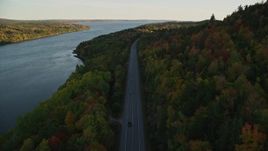 5.5K aerial stock footage flying over Route 3 along the river in autumn, Stockton Springs, Maine, sunset Aerial Stock Footage | AX149_116E