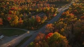 5.5K aerial stock footage tracking car on road through forest, autumn, Stockton Springs, Maine, sunset Aerial Stock Footage | AX149_132E