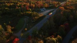 5.5K aerial stock footage tracking car on road through forest in autumn, Stockton Springs, Maine, sunset Aerial Stock Footage | AX149_133