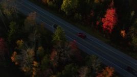 5.5K aerial stock footage tracking car on road through forest in autumn, Stockton Springs, Maine, sunset Aerial Stock Footage | AX149_135