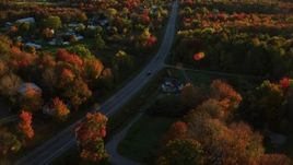 5.5K aerial stock footage tracking car on road through small town, autumn, Stockton Springs, Maine, sunset Aerial Stock Footage | AX149_138