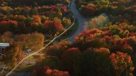 5.5K aerial stock footage tracking a car moving through smalll town, autumn, Stockton Springs, Maine, sunset Aerial Stock Footage | AX149_142