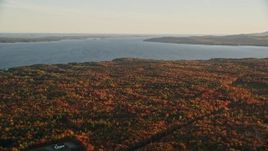 5.5K aerial stock footage flying by Belfast Bay, colorful forest in autumn, Searsport, Maine, sunset Aerial Stock Footage | AX149_151