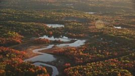 5.5K aerial stock footage flying high over a pond, colorful forest in autumn, Belfast, Maine, sunset Aerial Stock Footage | AX149_155E