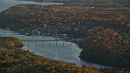5.5K aerial stock footage flying by small town, small bridge, Passagassawakeag River, autumn, Belfast, Maine, sunset Aerial Stock Footage | AX149_160E