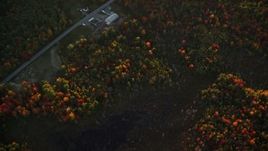 5.5K aerial stock footage of a bird's eye view over forest in autumn, rural homes, Belfast, Maine, sunset Aerial Stock Footage | AX149_163E
