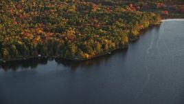 5.5K aerial stock footage flying by homes on Quantabacook Lake, forest in autumn, Searsmont, Maine, sunset Aerial Stock Footage | AX149_173