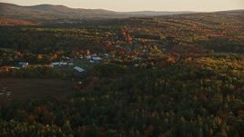 5.5K aerial stock footage approaching small rural town, colorful trees in autumn, Searsmont, Maine, sunset Aerial Stock Footage | AX149_174E