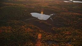 5.5K aerial stock footage approaching Colby Pond, tilt down, autumn, Palermo, Maine, sunset Aerial Stock Footage | AX149_194