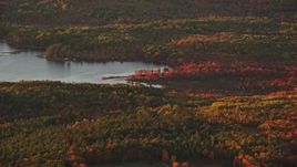 5.5K aerial stock footage flying by Sheepscot Pond, colorful forest in autumn, Palermo, Maine, sunset Aerial Stock Footage | AX149_195