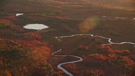 5.5K aerial stock footage flying by small rivers leading to a pond, autumn, Palermo, Maine, sunset Aerial Stock Footage | AX149_196