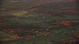 5.5K aerial stock footage flying by small farms, colorful trees in autumn, Windsor, Maine, sunset Aerial Stock Footage | AX149_204E