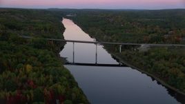 5.5K aerial stock footage approaching small bridge spanning Kennebec River, autumn, Augusta, Maine, twilight Aerial Stock Footage | AX149_239