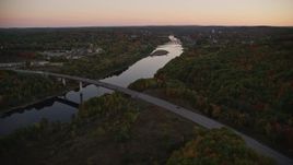 5.5K aerial stock footage flying by small bridge, Kennebec River, autumn, Augusta, Maine, twilight Aerial Stock Footage | AX149_241E