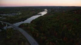 5.5K aerial stock footage flying over forest in autumn, approach Kennebec River, Augusta, Maine, twilight Aerial Stock Footage | AX149_242