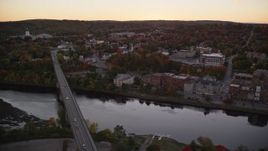 5.5K aerial stock footage flying by small bridges into downtown, Kennebec River, Autumn, Augusta, Maine, twilight Aerial Stock Footage | AX149_248